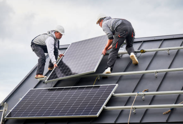 Technicians installing solar panels on a residential roof