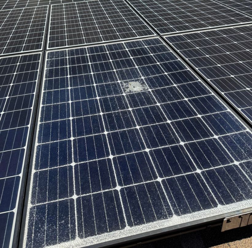 Close-up of solar panels showing soiling and buildup